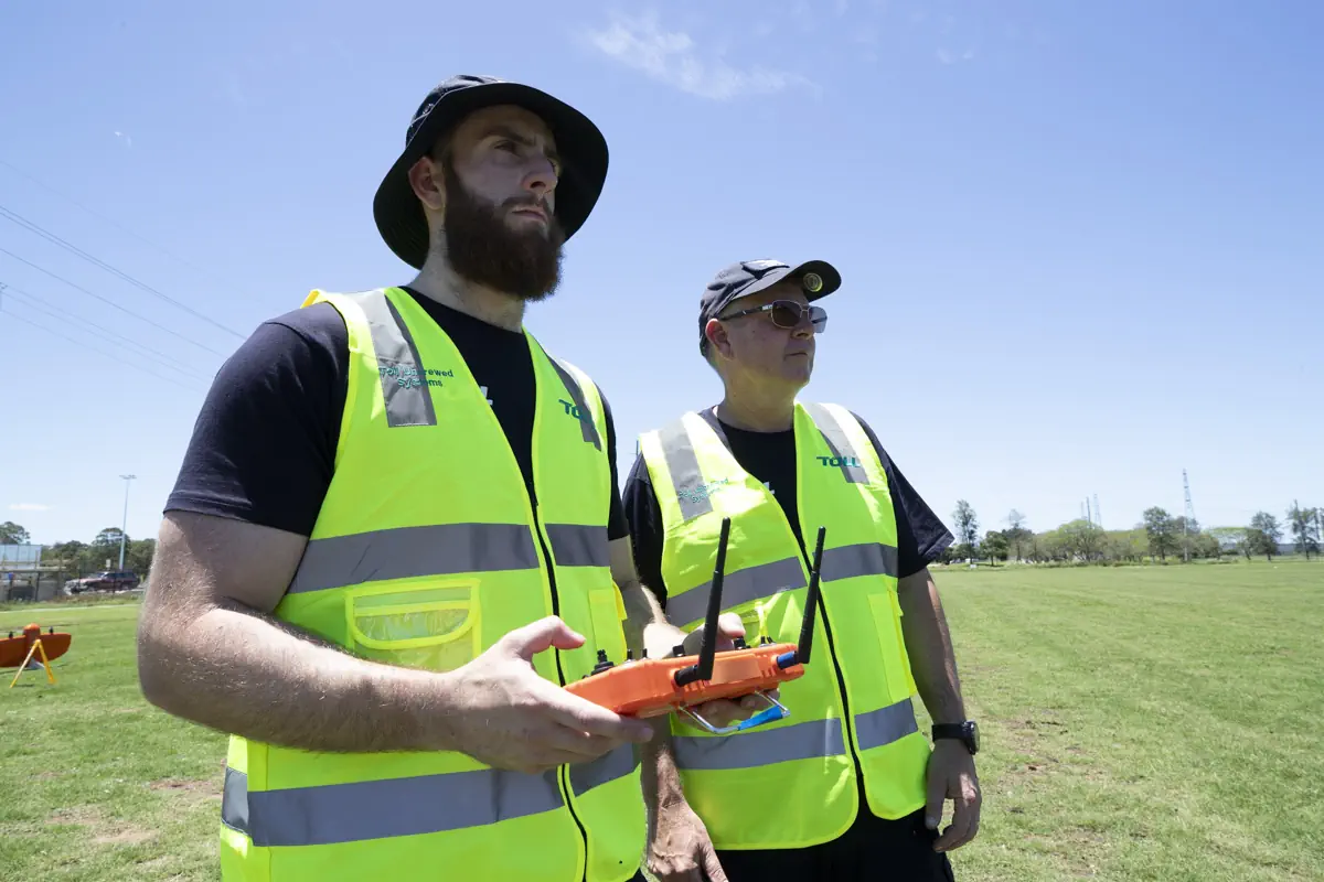 Drone hovering with trees in the background
